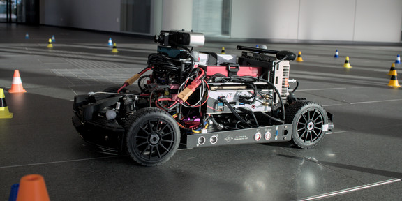 The AADC model car is being prepared for an autonomous race at the TU's 2023 Open House.