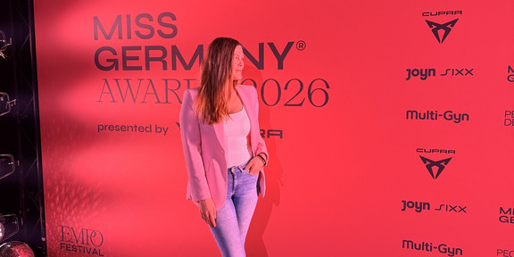 The image shows Natalia Ogorelysheva in front of a "Miss Germany Awards 2026" banner.
